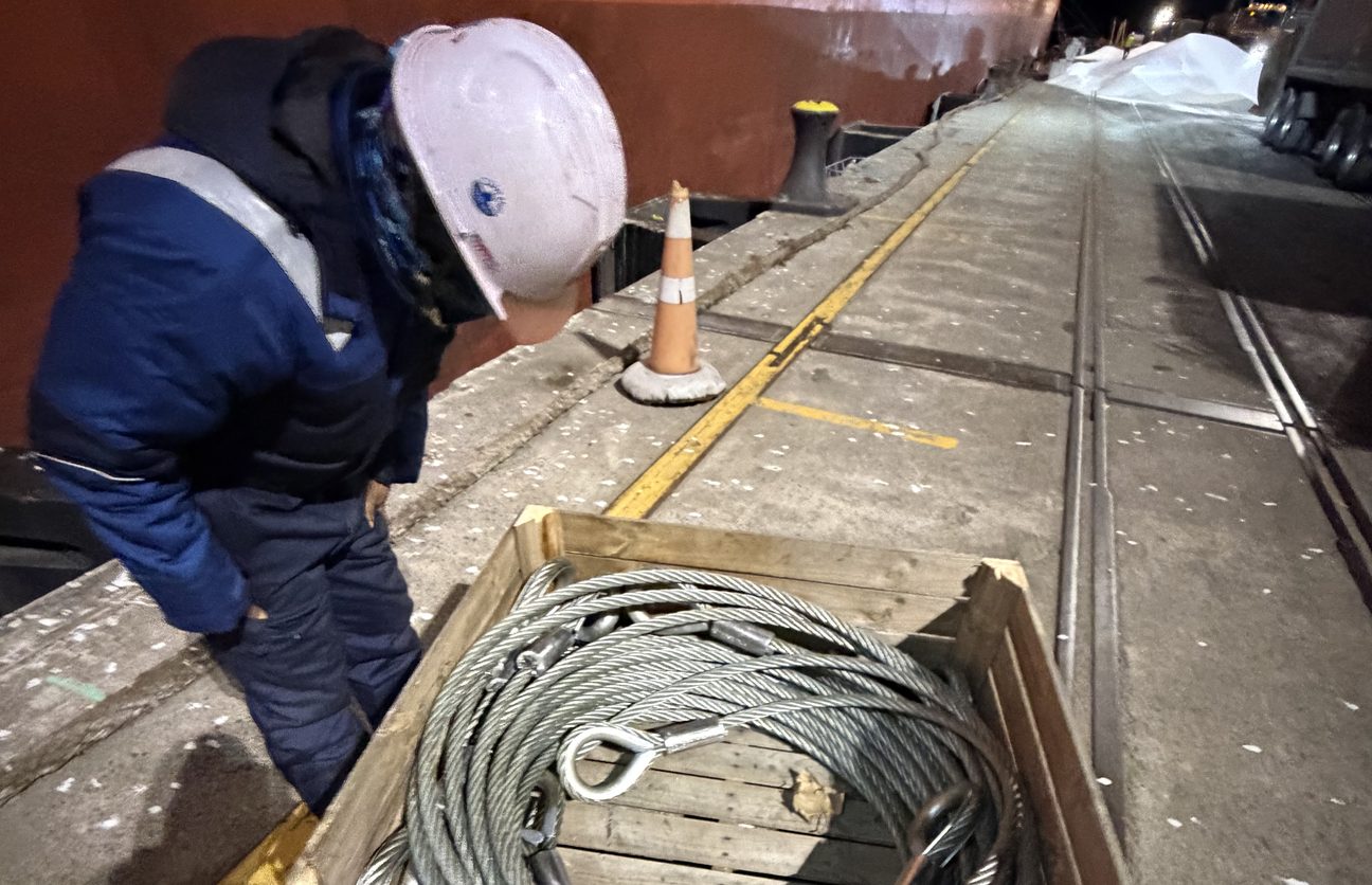 Aroha Providors crew member checking a crate of wire rope slings on the wharf alongside a vessel at the Port of Tauranga
